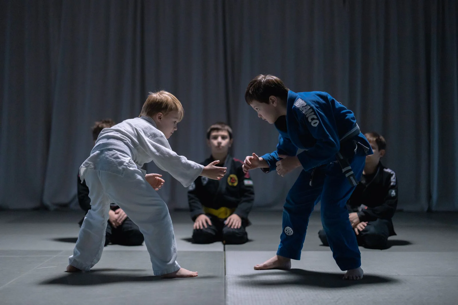 Children practicing Brazilian Jiu-Jitsu in gis